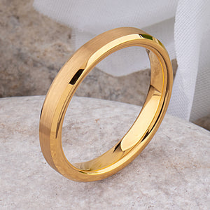 Yellow gold tungsten wedding ring with a brushed finish and polished beveled edges, showcasing elegant design.