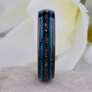 Black domed tungsten wedding ring with genuine meteorite center inlay and shimmering green-blue opal side inlays.