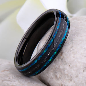 Black domed tungsten wedding ring with genuine meteorite center inlay and shimmering green-blue opal side inlays.