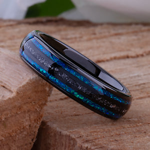 Black domed tungsten wedding ring with genuine meteorite center inlay and shimmering green-blue opal side inlays.