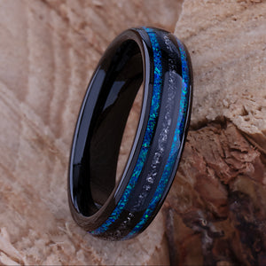 Black domed tungsten wedding ring with genuine meteorite center inlay and shimmering green-blue opal side inlays.