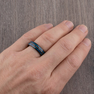 Black domed tungsten wedding ring with genuine meteorite center inlay and shimmering green-blue opal side inlays.