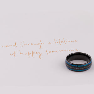 Black domed tungsten wedding ring with genuine meteorite center inlay and shimmering green-blue opal side inlays.