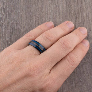 Black domed tungsten wedding ring with genuine meteorite center inlay and shimmering green-blue opal side inlays.